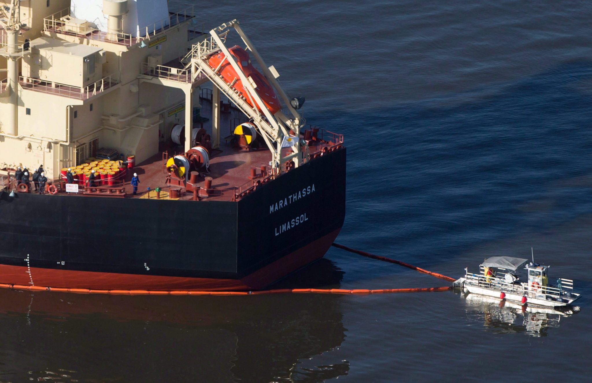 A spill response boat secures a boom around the bulk carrier cargo ship MV Marathassa after a bunker fuel spill on Burrard Inlet in Vancouver, B.C., on April 9, 2015. A ship that leaked more than 2,700 litres of bunker fuel into the waters off Vancouver almost two weeks ago will soon be given the go-ahead to dock at Vancouver's port. The Coast Guard says it has completed its decontamination of the MV Marathassa. THE CANADIAN PRESS/Darryl Dyck