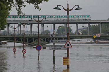 Road signs emerge on the banks of the Seine river next to the Bir Hakeim bridge during floods in Paris, Saturday, June 4, 2016. The level of the Seine started to drop after peaking earlier in the morning. Both the Louvre and Orsay museums were closed as officials said the Seine had been at its highest level in nearly 35 years. (AP Photo/Francois Mori)