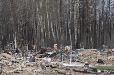 Crews work to clean up the wildfire destruction in Fort McMurray Alta, on Friday June 24, 2016. THE CANADIAN PRESS/Jason Franson