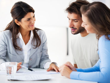 Financial consultant presents bank investments to a young couple. Taken at iStockalypse Milan.