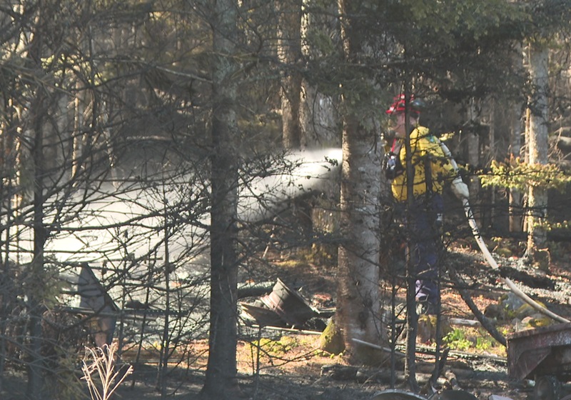 A firefighter putting water during the Stein Lake wildfire in 2023.