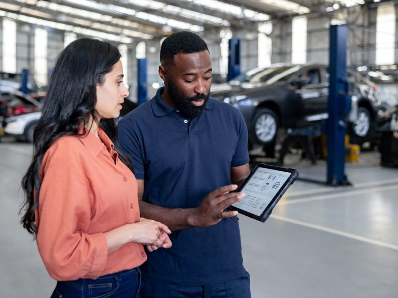 Customer meeting with an auto repair technician.