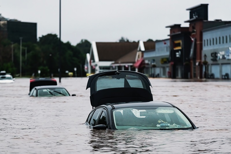 Vehicles sit in deep water in a shopping mall parking lot after a river overflows following record breaking rainfall.