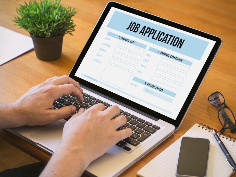 Man working on a laptop job application.